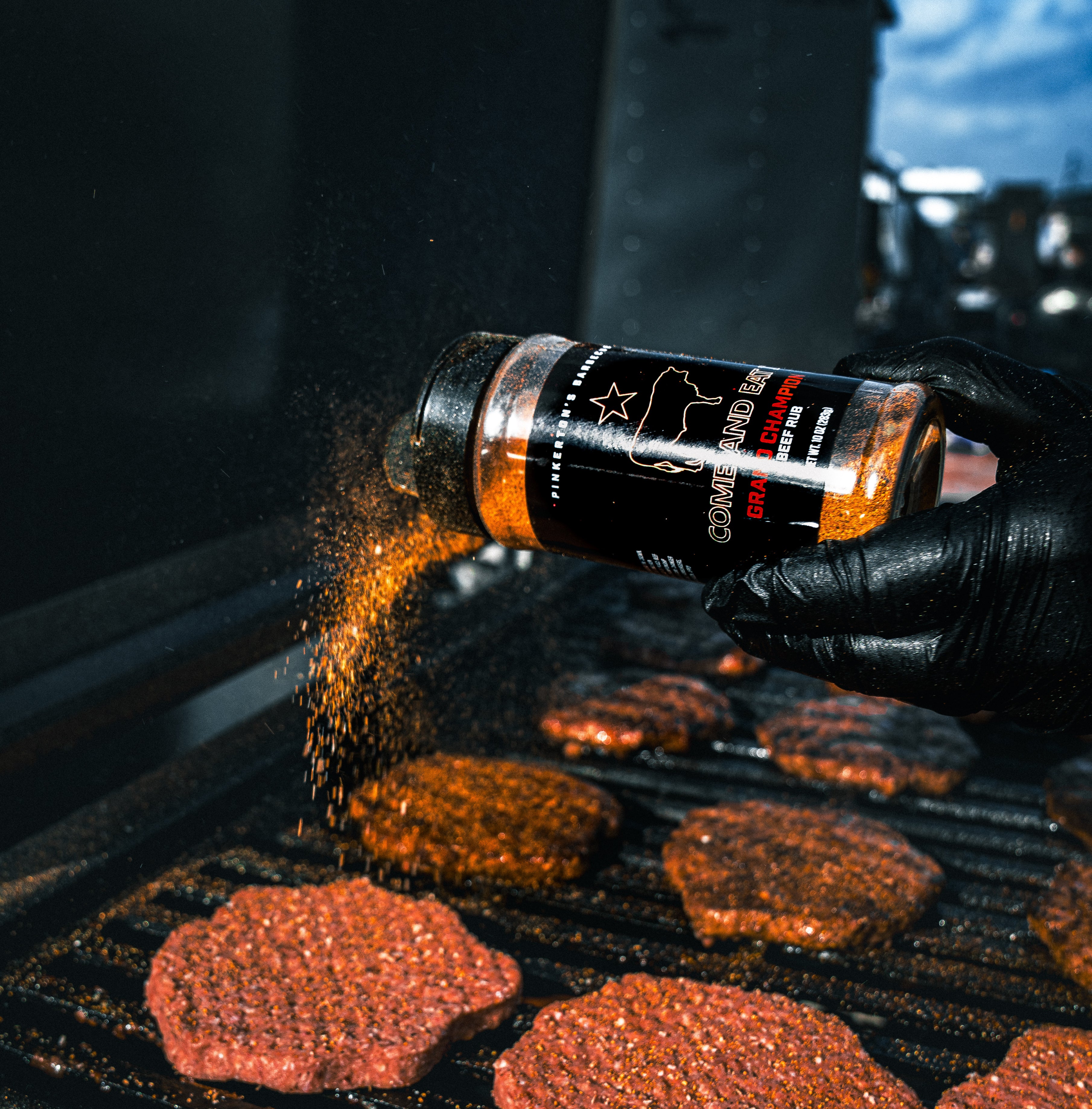 Grand Champion Rub going on some burgers on the grill