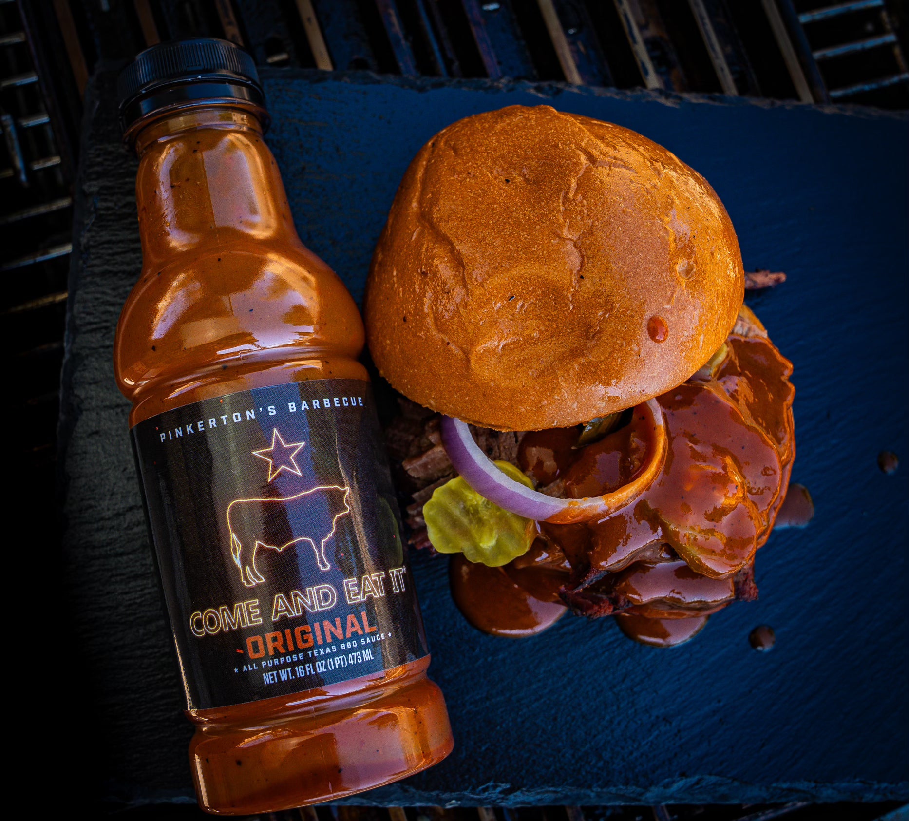 Pinkerton’s Original BBQ Sauce beside a brisket sandwich